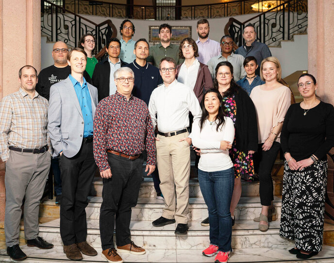 Image of 19 people standing on a staircase